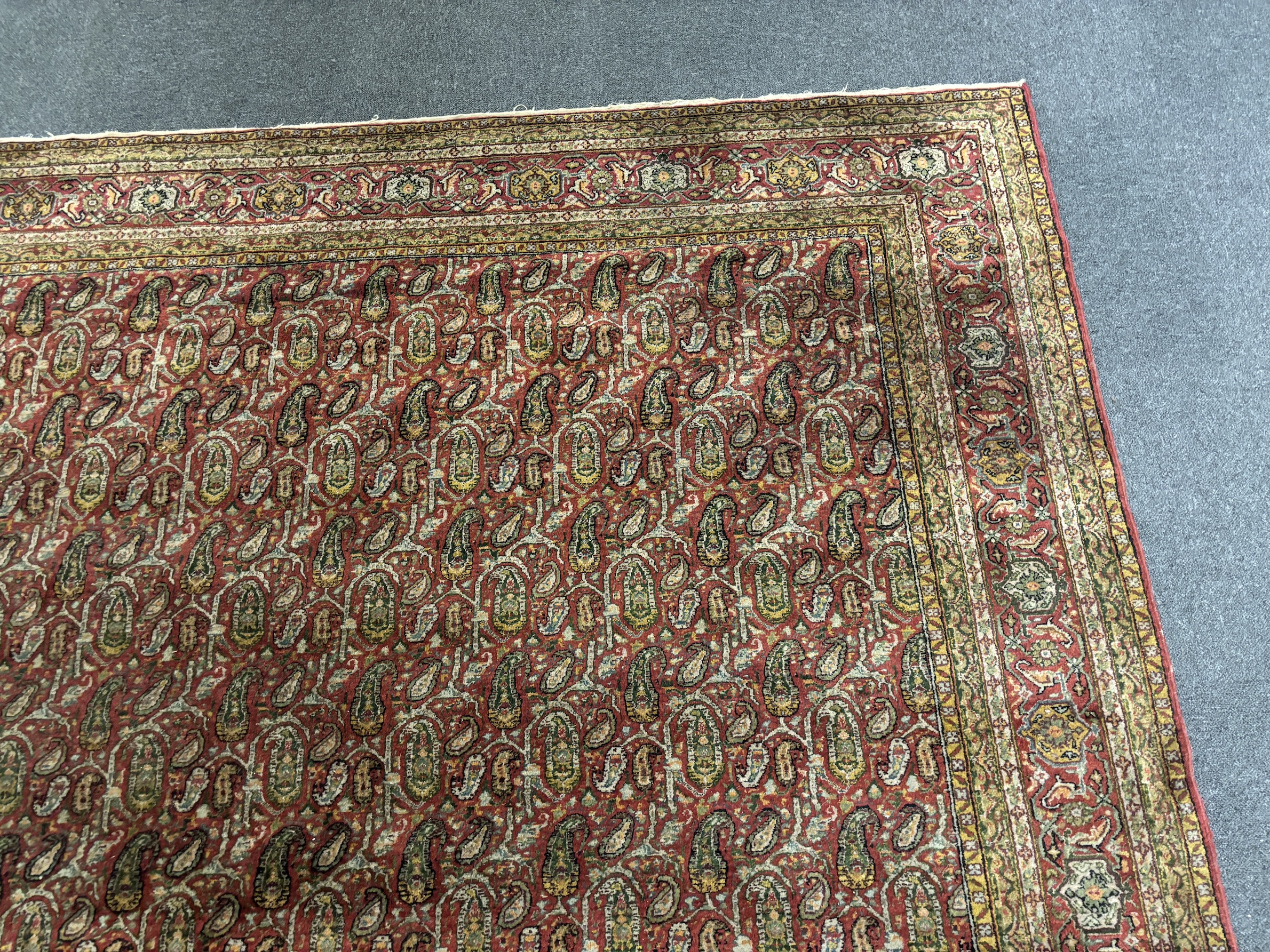 A Khorasan red ground carpet, approximately 12ft. X 9ft. (damage to one small area neatly repaired)